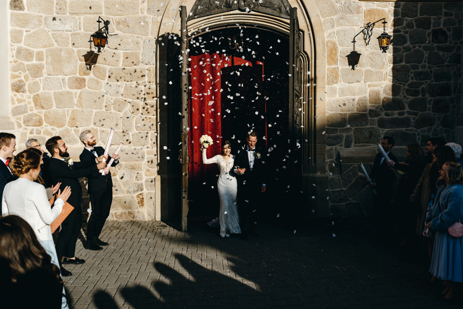 para młoda wychodzi z Bazyliki św. Mikołaja w Bochni po ceremonii ślubnej